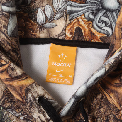 26SS × NIKE / DRAKE / NOCTA マルチモチーフ リアルツリーカモ スウェット パーカー (Pullover Hoodie Multi)